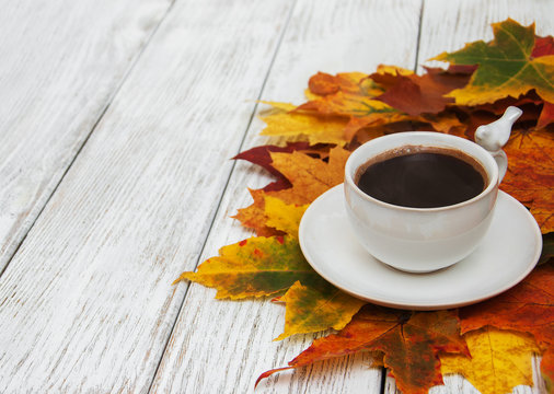 Cup of coffee and autumn leaves