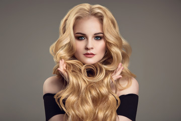 Obraz premium Blond woman with long curly beautiful hair.