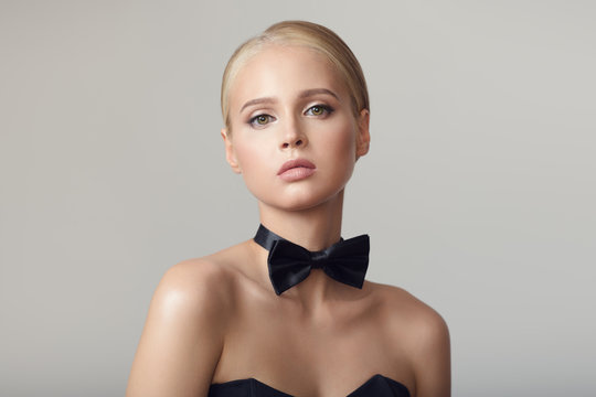 Portrait Of Fashion Woman. Black Bow Tie On Her Neck.