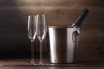 Image of two empty wine glasses, bottle of wine