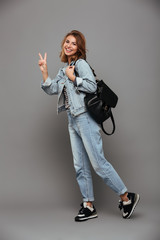 Full length portrait of a cute girl in denim jacket