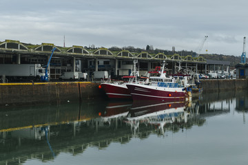 Fototapeta premium Fishing boats in a harbor. Trawler after fishing. Fishing industry, fishery. Commercial ship for seafoods in Dieppe, Normandy