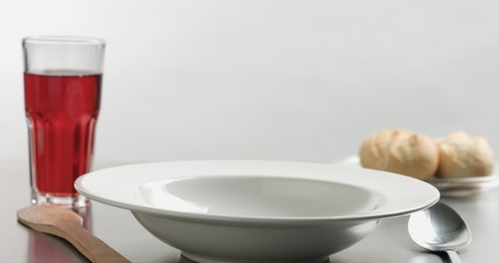 Delicious freshly made hot steaming chicken and lentil soup in a white wide-rimmed plate