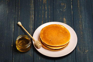 Tasty healthy breakfast - fresh pancakes with honey