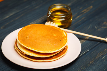 Tasty healthy breakfast - fresh pancakes with honey