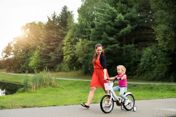 Mother and her cute little daughter in the nature.