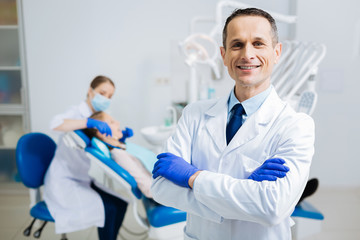 Delighted confident doctor looking at you