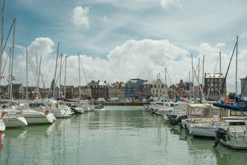 Yachts moored at quay port of Dieppe, France. Concepts of success, leisure, holiday, rich, tourism, luxury, lifestyle. Sunny Summer, blue sky. Toned