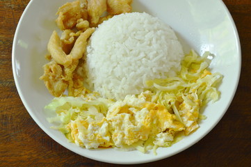 fried cabbage with egg and salty chicken on rice
