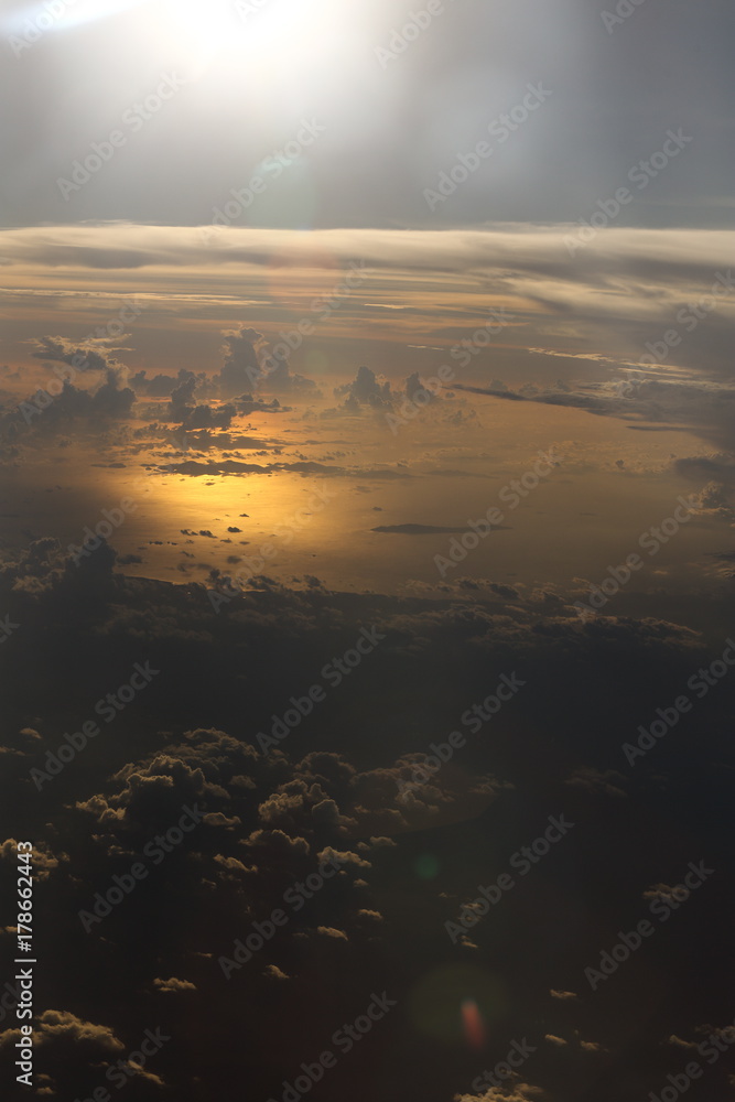 Wall mural sunset white cloud sky at high level attitude, view from window airplane