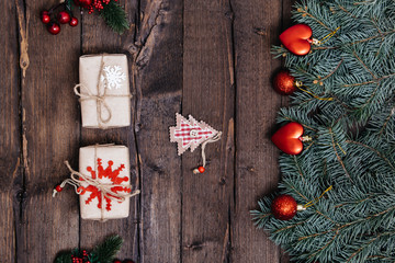 Christmas background with decorations, xmas tree and gift boxes on wooden board.