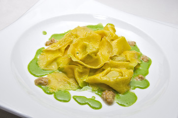 plate of ravioli pasta with basil sauce