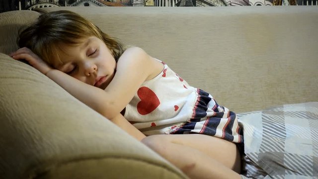 4K footage. Sleeping baby. A girl 4-5 years old in a dress fell asleep without undressing.