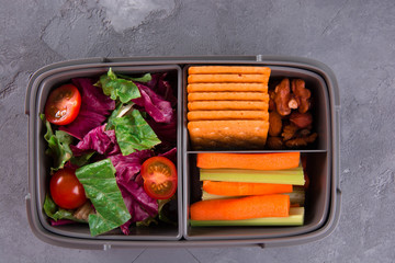 lunch box with healthy food. Meat, eggs, vegetables, fruits, nuts.