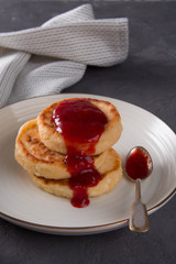 Syrniki with strawberry jam.