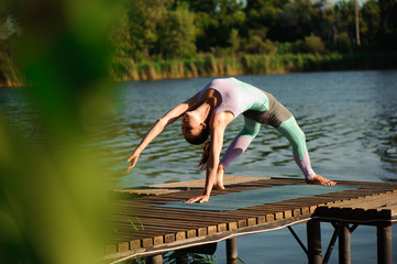 Young woman doing yoga in morning park
