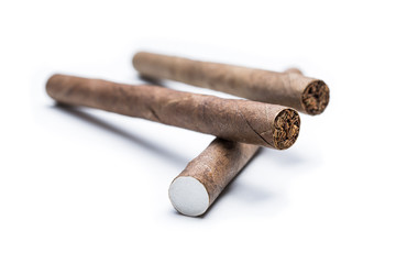 Macro Of Two Cigarillos On Top Of A Single Cigarillo Isolated On White Background