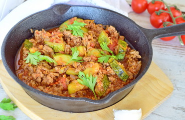 Homecooked dish with minced meat and zucchini fried in a pan