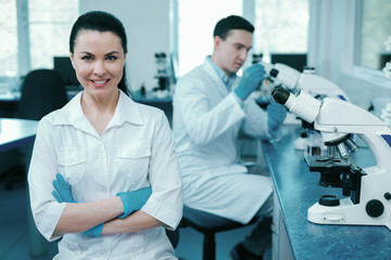 Confident scientist crossing arms on chest