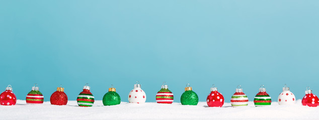 Line of little bauble ornaments on a snow mound
