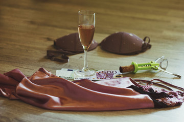 sexy lingerie, glass of wine, a corkscrew and money on the floor