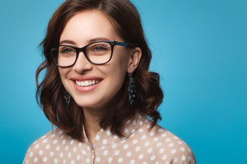 Brunette woman wearing glasses smiling