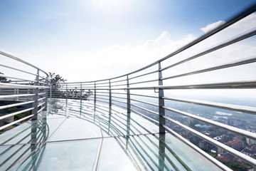 glass pedestrian bridge over hill