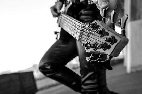 Close-up photo of electric bass guitar player.  Live music background, electric bass guitar