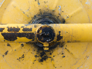 mechanical detail of an old yellow cement mixer dirt with grease
