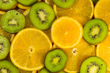Fototapeta premium Sliced kiwi fruits and oranges for background