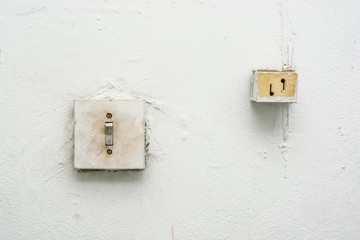 Close up old white light switch on wall