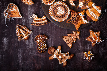 Christmas homemade gingerbread cookies on dark wooden table