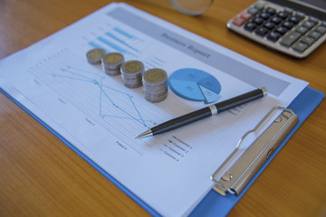 Graphs and charts with stacks of coins