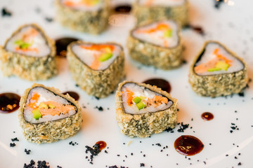 Close up delicious triangle sushi rolls on plate
