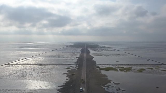 Aerial of Low tide path to the island Mand&oslash; in Denmark, only access by car &ndash; 4K