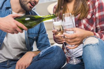 couple sitting on floor with champagne