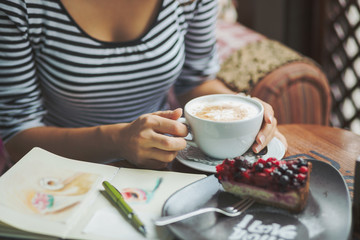 Young woman sitting indoor in urban cafe