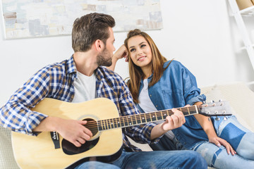 Couple on sofa with guitar