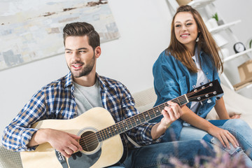 Couple on sofa with guitar