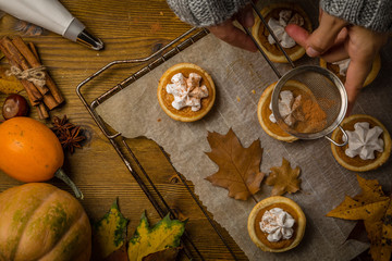 Thanksgiving concept - making mini pumpkin pies