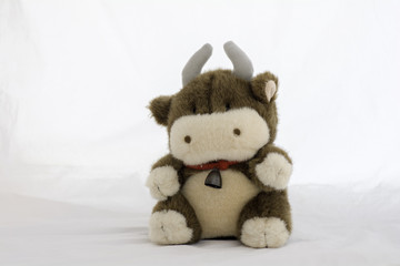 stuffed animal cow on a white background .