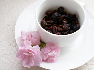 dried coffee cherries in a white coffee cup