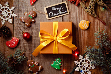 Beautiful Christmas background with gingerbreads, sweets and gift on wooden background. Merry Christmas postcard 2018