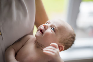 little newborn baby in the arms of mother close up shoot