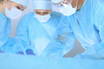 Medical team performing operation. Three of surgeons at work are busy of patient. Medicine, veterinary or healthcare and emergency in hospital