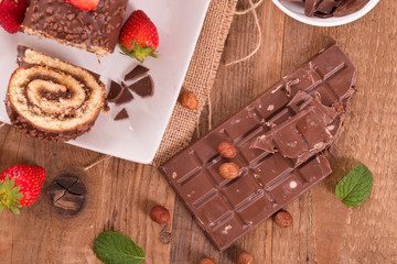 Chocolate roll with hazelnuts and strawberries. 