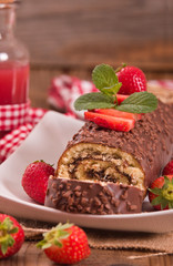 Fototapeta na wymiar Chocolate roll with hazelnuts and strawberries. 