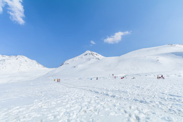 Fototapeta na wymiar The snow mountains of Tateyama Kurobe alpine with blue sky background is one of the most important and popular natural place in Toyama Prefecture, Japan.