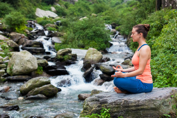 Woman in Padmasana outdoors