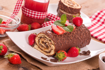 Chocolate roll with hazelnuts and strawberries. 